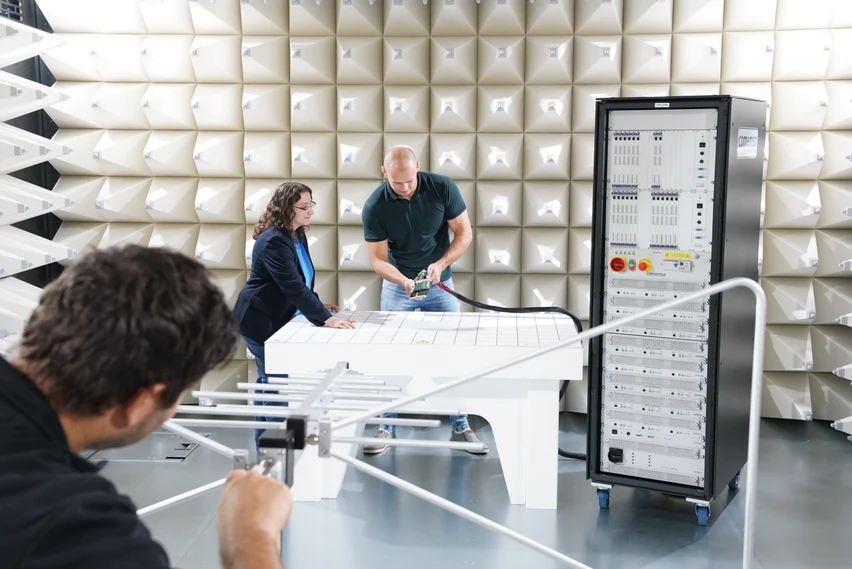 The comemso team working with test equipment in the in-house EMC chamber.