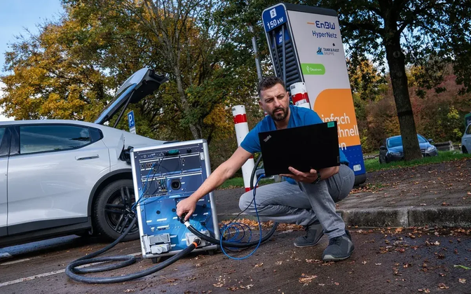 Engineer using EVCA Multi Mobile and a laptop during a real charging analysis