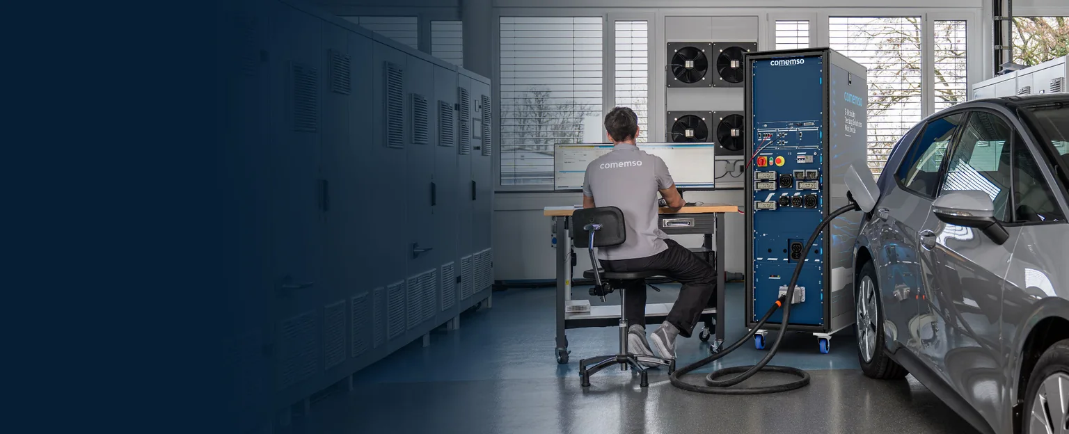 An electric vehicle connected to an EVCA test system: an engineer investigates charging behaviour in the lab