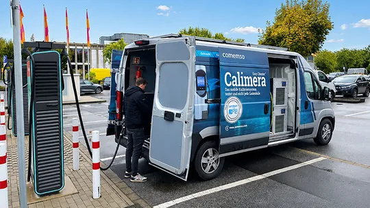 Calimera vehicle and employee carrying out mobile calibration at an outdoor charging point