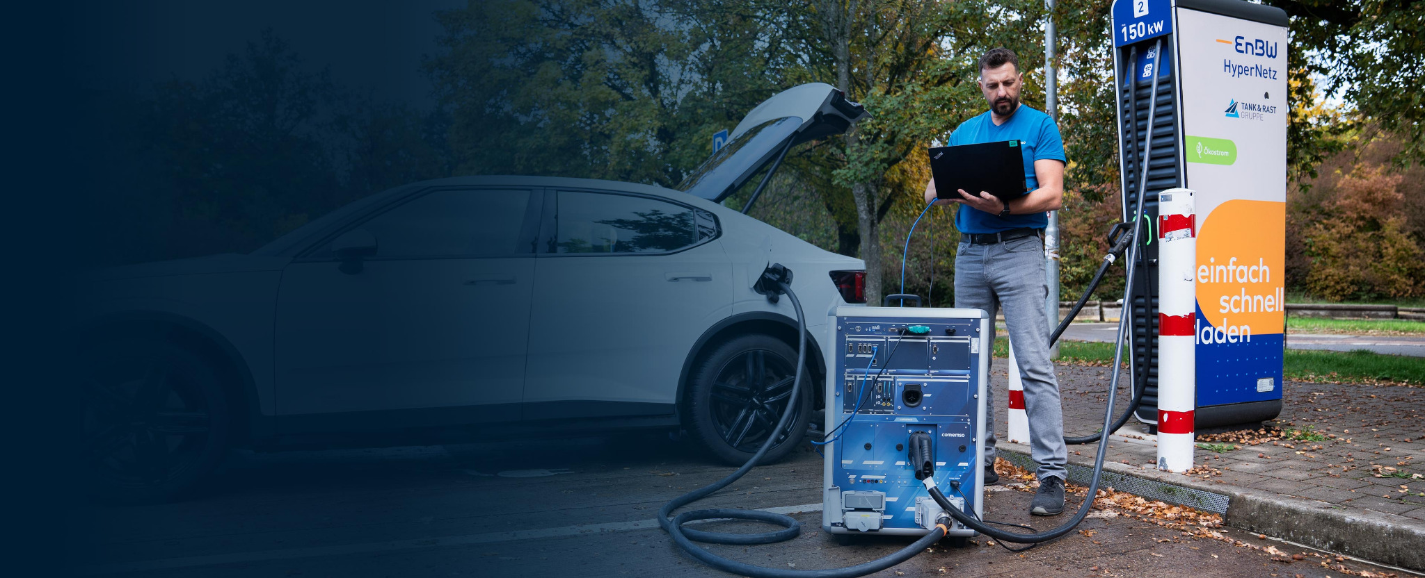 Engineer analysing a charging session with a comemso charging analyzer at a public charging station